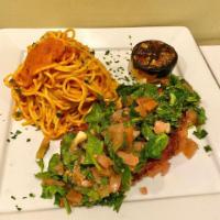 Pollo Milanese · Lightly breaded chicken breast topped with chopped tomatoes and spinach chiffonade lemon and...