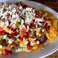 Chorizo Nachos · House ground chorizo, black beans, pickled jalapeno, bell pepper puree, habanero creme and s...