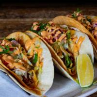 Crunch Taco · Hard shell wrapped with soft shell, cheese sauce, shredded lettuce, diced tomato and a zesty...