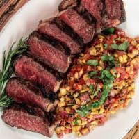 New York Strip · Black Angus Strip Steak marinated in a tequila served with a roasted corn salsa, and mashed ...