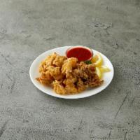 Calamari Fritti · Golden fried calamari served with a marinara sauce dip.