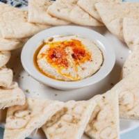 Hummus · Chickpeas blended with tahini, olive oil, garlic, and herbs. Served with pita bread.
