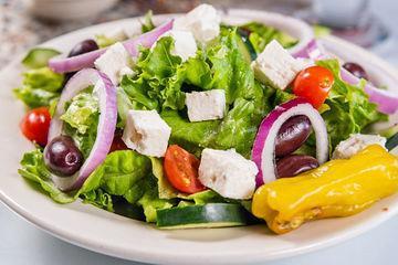 1/2 Greek Salad · Fresh greens, tomatoes, cucumbers, onions, feta cheese, Kalamata olives, and Greek peppers. Served with pita bread.