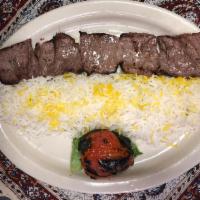Filet Mignon Chelo Kebab Barg · Marinated and pounded kebab broiled over an open fire. Served with grilled tomato and plan b...