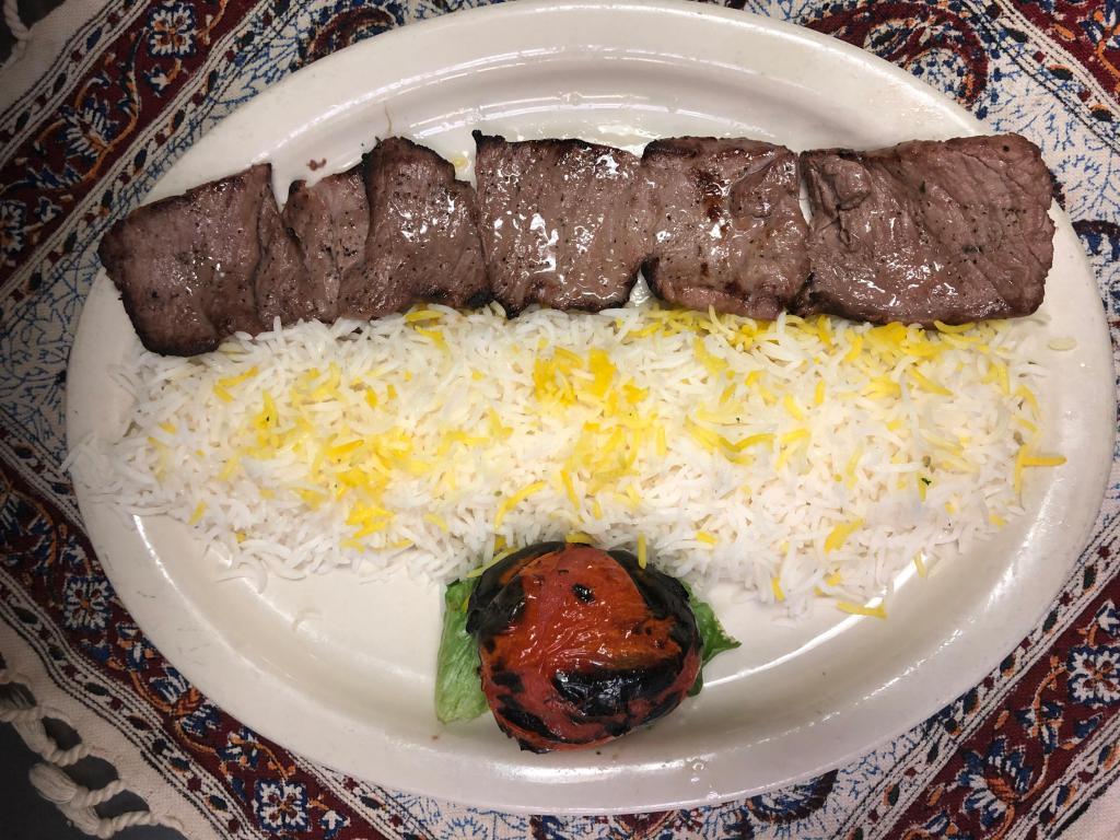 Filet Mignon Chelo Kebab Barg · Marinated and pounded kebab broiled over an open fire. Served with grilled tomato and plan basmati rice chelow.