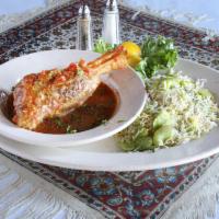 Lamb Shank Mahiche · Lamb shank slowly cooked in tomato sauce with herbs, garlic, and onions. Served with grilled...