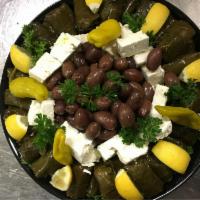 Dolmas with full grek salad · Served over a full Greek salad.