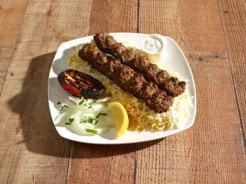 Koobideh Kebab Entrée · 2 skewers of lean ground beef marinated with saffron and special house seasoning. Served with basmati rice, grilled tomatoes and tzatziki sauce.