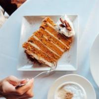 Carrot Cake · Cream cheese icing, toasted pecans, whipped cream and dusted with cinnamon.