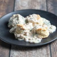 Biscuits and Gravy · 2 of Aunt Thelma’s biscuits with sausage and basil infused bechamel sauce with an egg