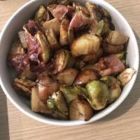 Herb Roasted Potatoes · Served with crispy Brussels sprouts and prosciutto.