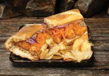 The Buffalo Grind Sub · Tender breaded chicken marinated in buffalo wing sauce, tangy ranch, red onions, Gorgonzola,...