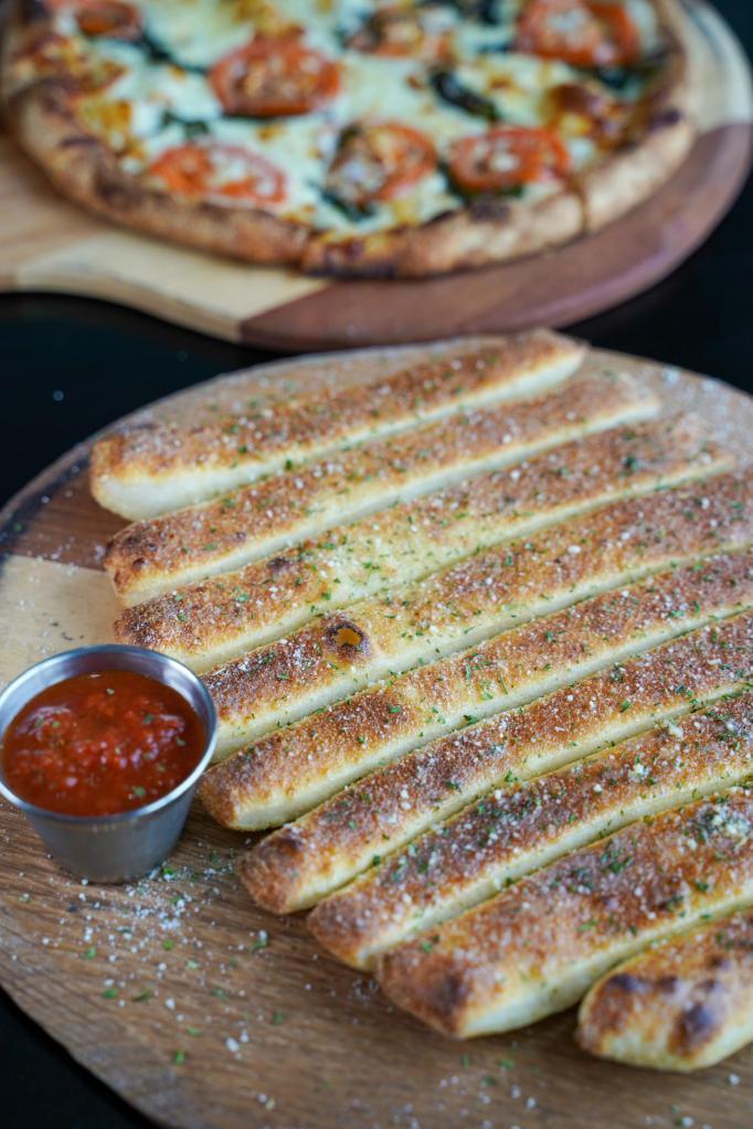 Breadsticks · Handcrafted using our fresh baked dough, sliced into approx 10 pieces, topped with garlic butter, served with house marinara.