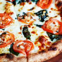 Margherita Pizza · Roma tomatoes, fresh basil, fresh garlic, whole-milk mozzarella, extra virgin olive oil.