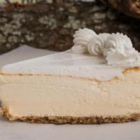 NY Style Cheesecake · Smooth & creamy classic New York style cheesecake, topped w/a hint of light whipped cream.