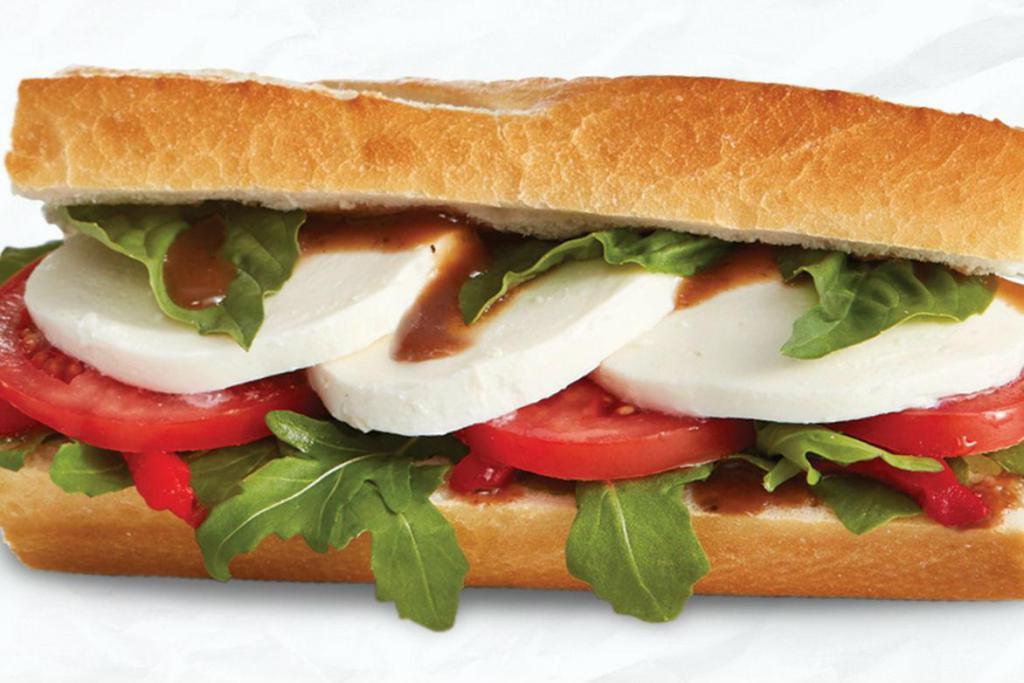 Tomato Mozzarella Sandwich · Fresh mozzarella, tomato, roasted red pepper, arugula, basil, balsamic vinaigrette, baguette. Vegetarian.