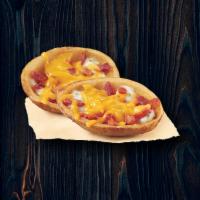 Potato Skins · Creamy garlic sauce, stuffed with bacon and filled with mozzarella cheese on top.