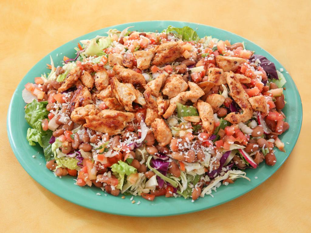 Margarita Salad · Made with fresh romaine lettuce, jicama, red and green cabbage, carrots, radishes, pinto beans, salsa fresca and Mexican cheese with tangy lime vinaigrette.