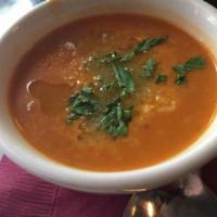 Tomato Bisque Soup · House made tomato soup, Parmesan and basil oil. Gluten free.