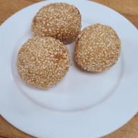 24. Fried Sesame Seed Dumplings (3 pieces) · Glutinous rice flour stuffed with sweet lotus seed flavored filling, deep fried and covered ...