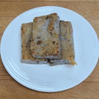 30. Pan Fried Taro Cake (3 pieces) · Rice flour and minced taro, formed into small rectangular cakes and pan fried.