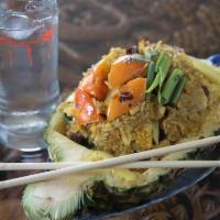 72. Pineapple Fried Rice · Aromatic fried rice with jumbo shrimps, pineapple, raisin, onion, tomatoes, curry powder and...