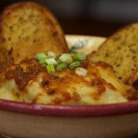 Homemade Beef Lasagna · Layers of pasta, ground beef and ricotta cheese topped with bolognese sauce and mozzarella c...