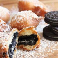Deep Fried Oreos · Classic oreo cookies coated deep fried to perfection and sprinkled with powdered sugar.