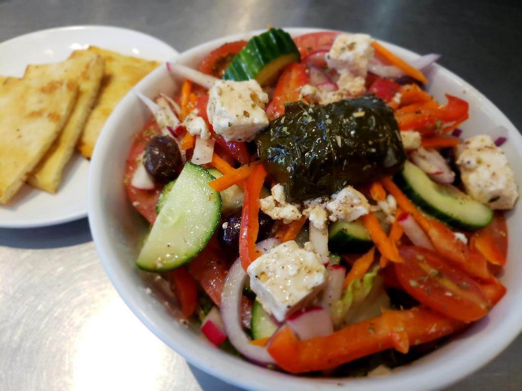 Greek Salad · Romaine lettuce , tomato, cucumber, red onion, pepper, carrots, radish, olives, feta cheese and red wine vinaigrette. Served with pita bread.