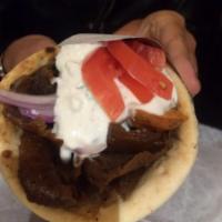 Lamb Gyro Pita Sandwich · Dressed with tomato, red onion, fries and your choice of sauce