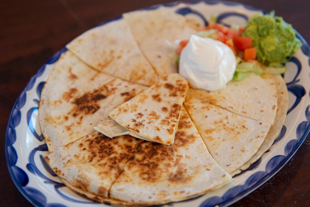 Quesadillas · Crispy choice of flour or corn tortillas, filled with blend of Monterey and cheddar. Chicken, beef or picadillo.
