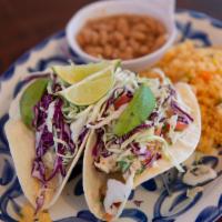 Baja Fish Tacos · Two flour or corn tortillas filled with wild alaskan cod lightly fried in our negra modelo b...