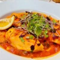 Pescado Veracruz · A 7 oz filet of Wild Alaskan Halibut pan seared and then finished in tangy sauce made from c...