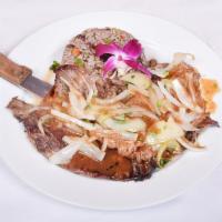 Bistec Encebollado Palomilla · Palomilla steak with caramelized onions served with moros y christianos (mixed white rice an...