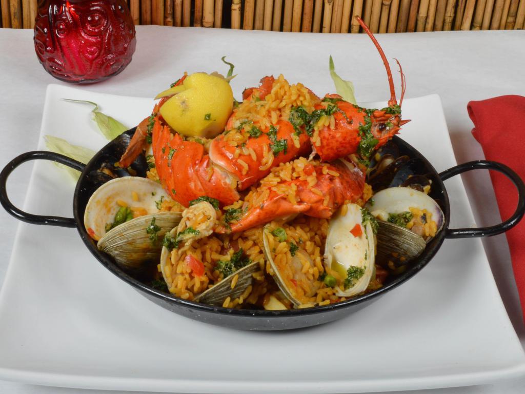 Havana Paella · Signature paella in saffron rice mixed with lobster, shrimps, calamari, mussels, clams and Cuban sausage and chicken bites. 