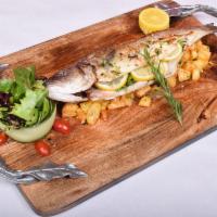 Lubina Castro · Slow roasted whole branzino with spicy roasted potatoes served with a garlic and lemon sauce.