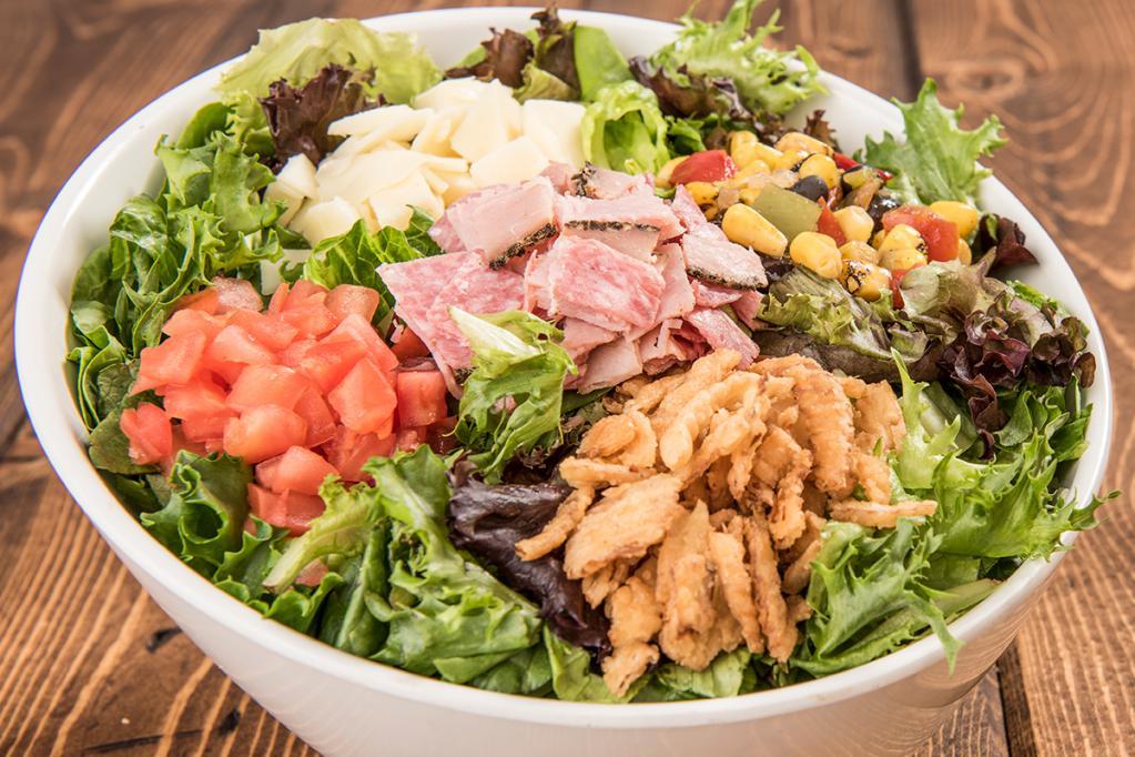 Cap's Chopped Salad · Think our popular Italian sub but on a salad! Salami, capacolla, prosciuttini, provolone cheese, tomatoes, and black olives on a bed of fresh chopped lettuce. Served with red wine vinaigrette. 