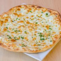 Traditional Cheese Flatbread · Mozzarella and feta cheese garnished with parsley.