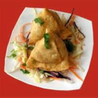 Vegetable Samosa · Golden fried pastry puffs stuffed with spiced peas and potato.
