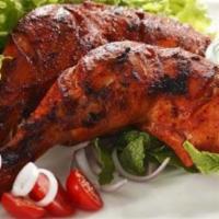 Tandoori Chicken · Leg and breast. Half a chicken marinated with yogurt and spices. Served with basmati rice.