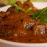 Ruby Lamb Korma · Tender chunks of lamb cooked in a special silky korma sauce along with potatoes, garnished w...