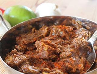 Lamb Vindaloo · Bonelles lamb cooked with potatoes in a hot vindaloo sauce, comes with rice.