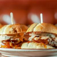 Cheeseburger Sliders · Two 100% natural Angus ground chuck patties, cheddar, grilled onions, pickle and secret sauce.