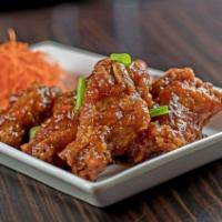 32. Thai Chicken Wings · Five pieces. House marinated chicken wings served with pineapple sweet and sour sauce.
