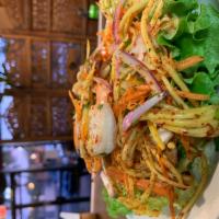 40. Mango Salad · Shredded fresh green mango with grilled shrimp, red onion and lime juice, topped with cashew...