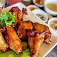 A6. (Chicken Wings) Canh Ga Hue Oi · 6 fried chicken wings marinated with fish sauce, ground red pepper and garlic.