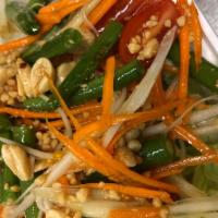 Papaya Salad · Som tum Thai. Salad, cherry tomatoes, long bean and roasted peanuts with lime dressing. Glut...