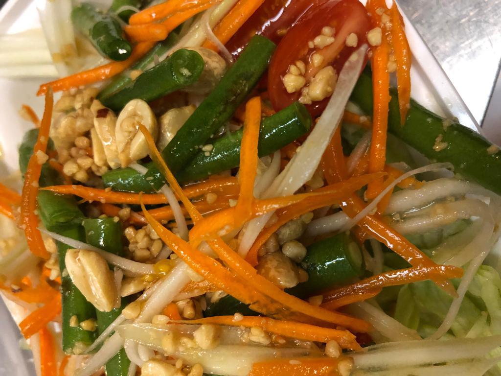Papaya Salad · Som tum Thai. Salad, cherry tomatoes, long bean and roasted peanuts with lime dressing. Gluten free.