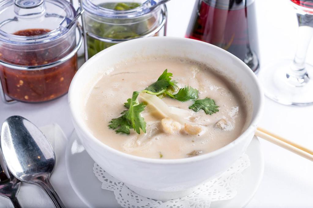 Tom Kha Soup · Creamy coconut soup with Thai herbs, onions, mushrooms and cilantro.