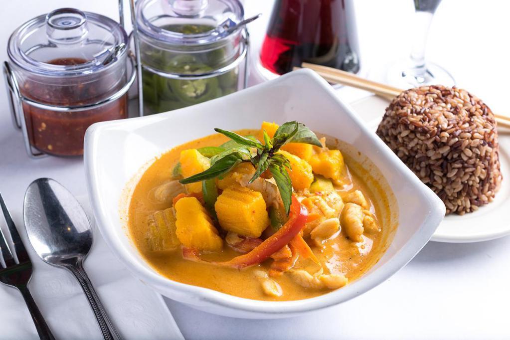 Pumpkin Curry · Pumpkin, carrots, bell peppers and sweet basil. Simmered in red curry and coconut milk. Spicy.